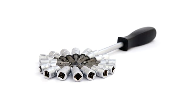 Screwdriver with various metal nozzles on a white background
