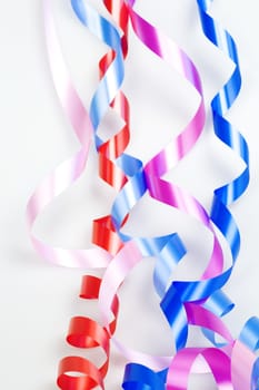 varicolored decorative ribbons on a white background