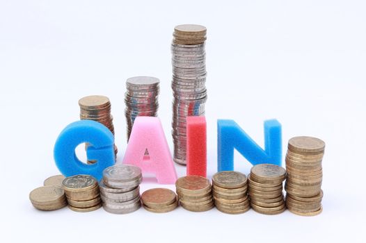 Gain word spelled surrounded by coins