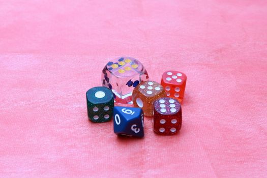 6 coloured dices on pink background