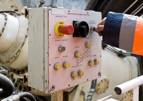 Close-up of hand on key maintenance control panel