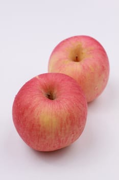 A pair of red apples on white background