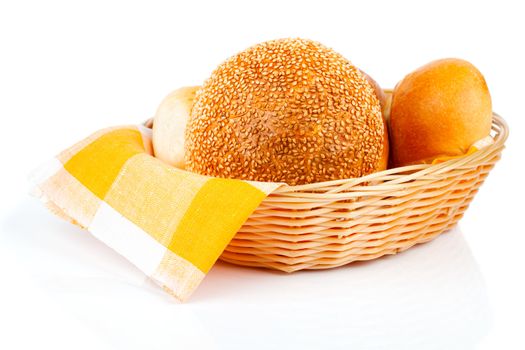 fresh baked buns in a basket on white background