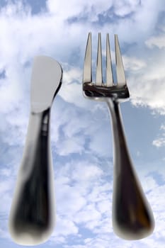 fork isolated against a cloudy background as in dining out