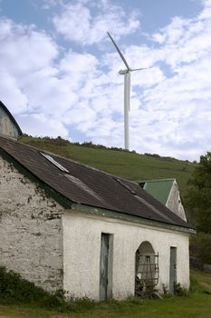 windmill above abandoned farm on lush irish countryside landscape in glenough county tipperary ireland