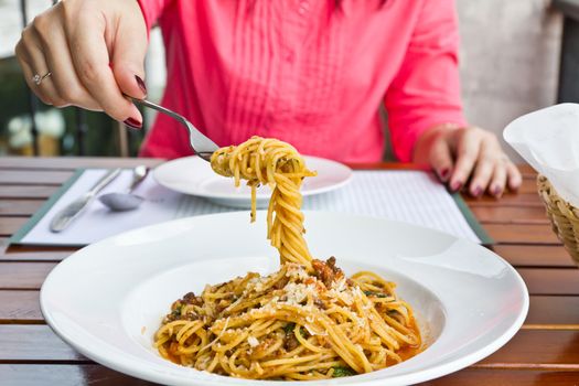 Spaghetti noodles with meat sauce on white plate