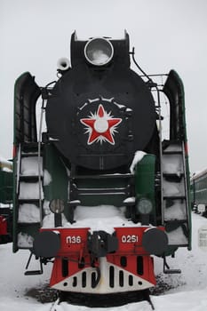 old locomotive at a train station in winter