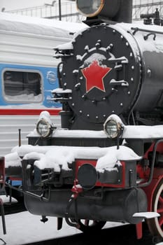 old locomotive at a train station in winter