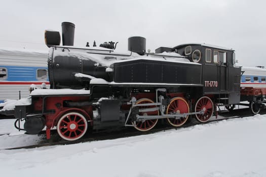 old locomotive at a train station in winter