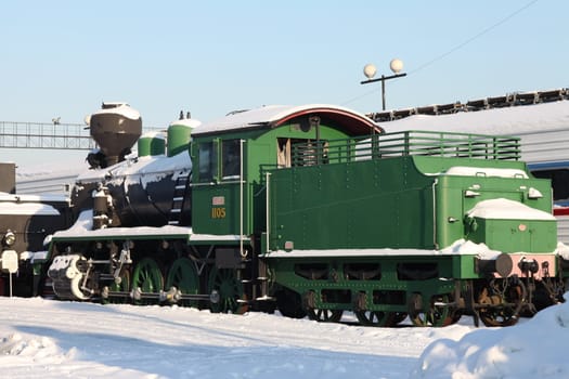 old locomotive at a train station in winter