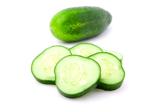 Cucumber and slices isolated over white background.