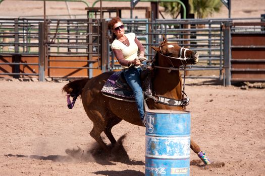 Women horse barrel race in corral in las vegas