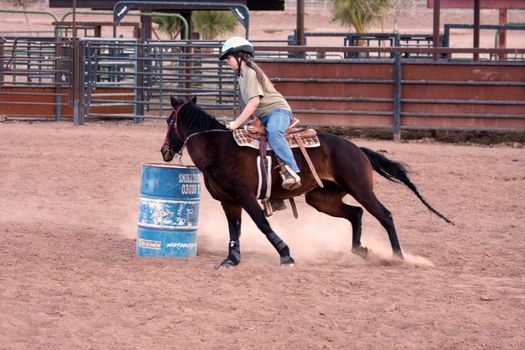 Women horse barrel race in corral in las vegas