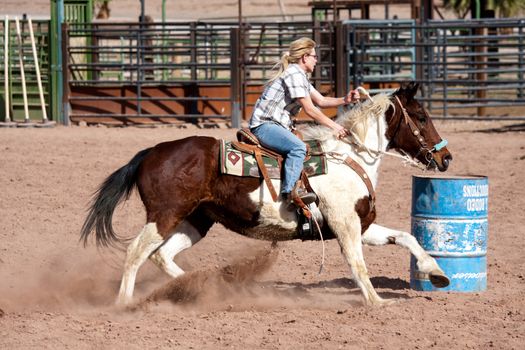 Women horse barrel race in corral in las vegas