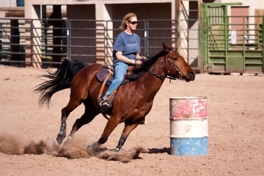 Women horse barrel race in corral in las vegas