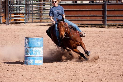 Women horse barrel race in corral in las vegas