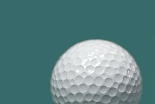 Golf ball on green background