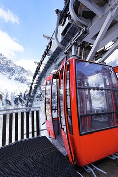 red cable car in winter in french alps