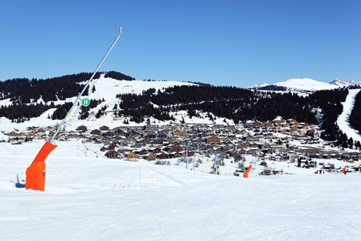 snowmaker on ski track in french alpine mountain