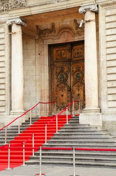 Red carpet over staircase for government officials or celebrities leading to beautiful historical stone building in Europe, hotel de ville, Lyon, France.