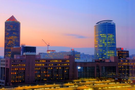 Beautiful lights of a sunset over a modern area of an old city with train TGV station in the foreground, Lyon, France.