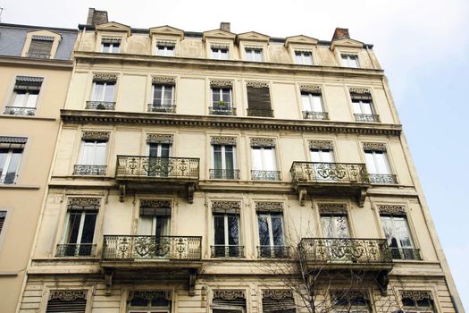 Architecture :Old building apartments or flats in a European city with beautifuly crafted wrought iron balconies.