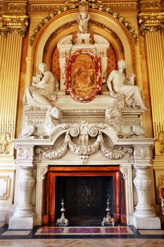 Magnificent marble fireplace with people and lions in european building, hotel de ville in Lyon France, rococo style.