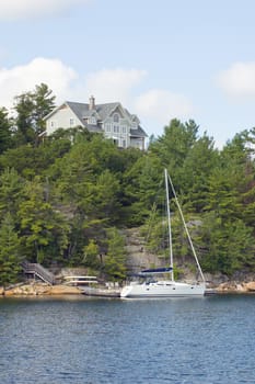 Lone cottage on high stone lake shore