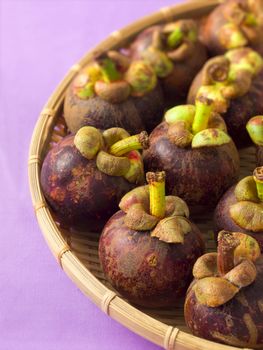 close up of a basket of mangosteens