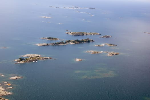 Islands and sounds on surface of water in sunlit