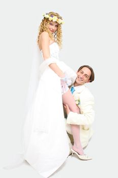 Young couple posing in a studio on the wedding day 