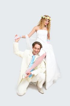 Young couple posing in a studio on the wedding day 