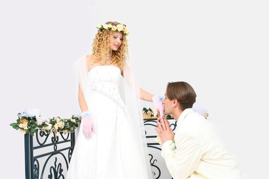 Young couple posing in a studio on the wedding day 