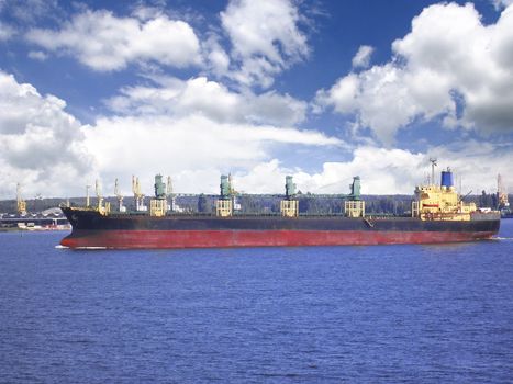 The passage of the cargo ship on a waterway