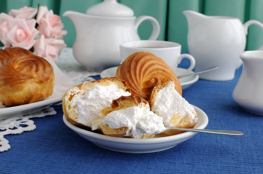 Eclairs with cottage cheese and protein fillings in the context of a close-up on a plate with a cup of coffee