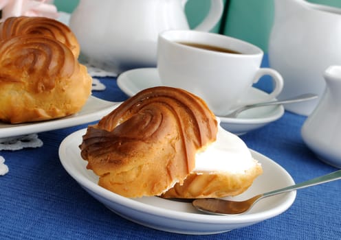 Eclairs with cottage cheese and protein fillings in the context of a close-up on a plate with a cup of coffee