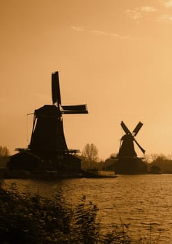 Silhouettes of traditional Dutch windmills in Zaanse Schans.