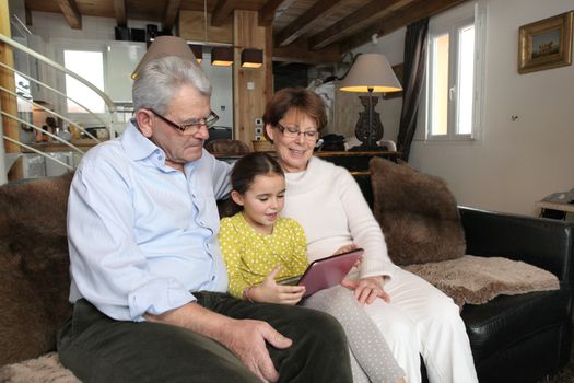 Old couple sat with their granddaughter