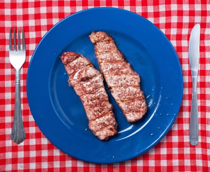 Argentinian grilled meat on blue plate.