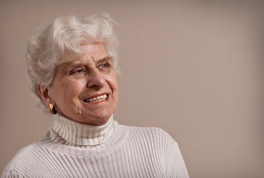 Senior lady portrait, smiling with copy space. 