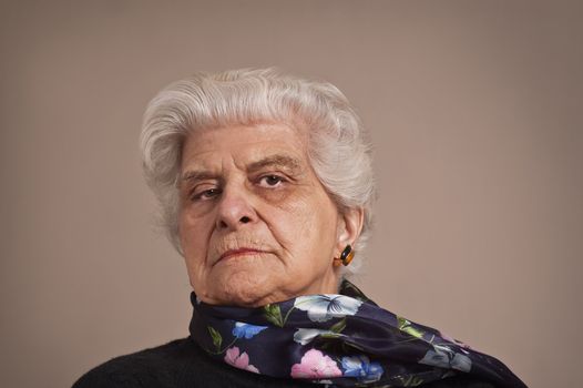 A portait of an elderly lady dressed in black,  with copy space.  