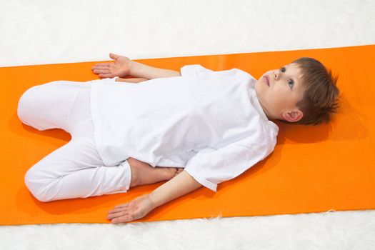 Children's yoga. The little boy does exercise. 