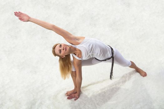 Young beautiful girl is professionally engaged in yoga 