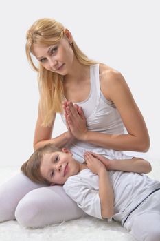 Mother and son do yoga before bed 