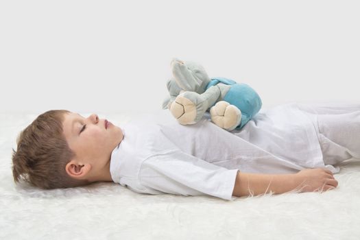Children's yoga. Yoga before a sleeping. The kid with a favourite toy