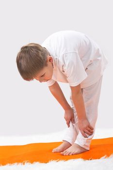 Children's yoga. The little boy does exercise. 