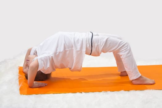 Children's yoga. The little boy does exercise. 