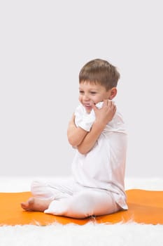 Children's yoga. The little boy does exercise. 