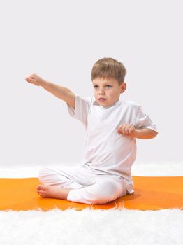 Children's yoga. The little boy does exercise. 