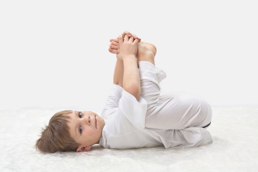 Children's yoga. The little boy does exercise. 